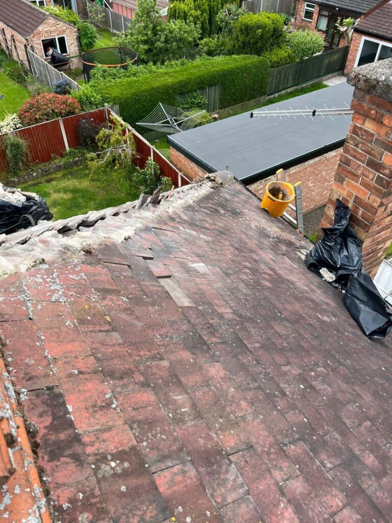 This is a photo of a roof where the hip tiles have been removed, and are just about to be replaced. Works carried out by West Bridgford Roofing Repairs