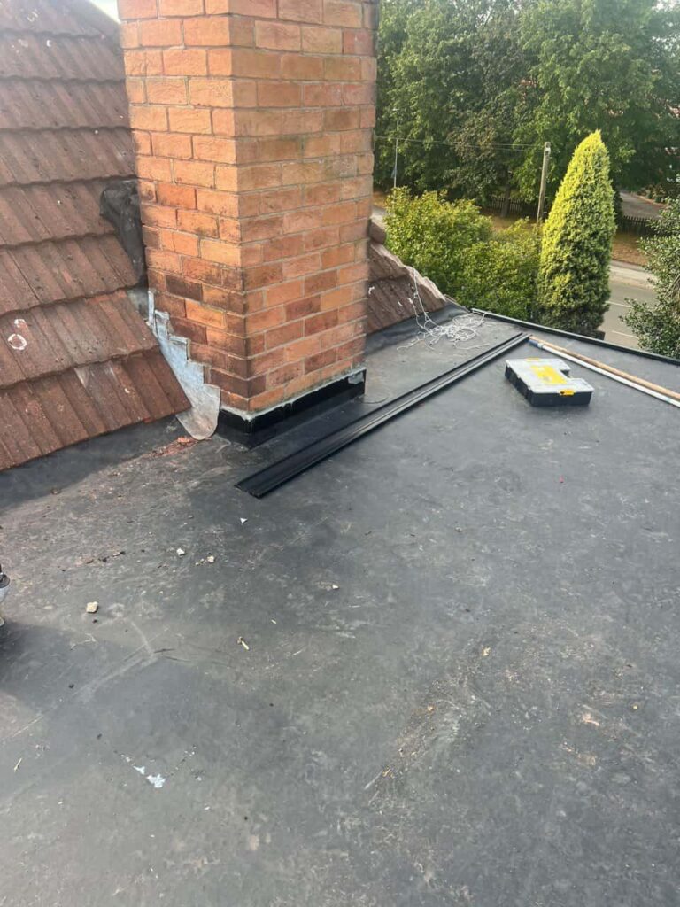 This is a photo of a flat roof which has just been repaired, there is also a chimney stack and some leadwork has also been dressed. Works carried out by West Bridgford Roofing Repairs